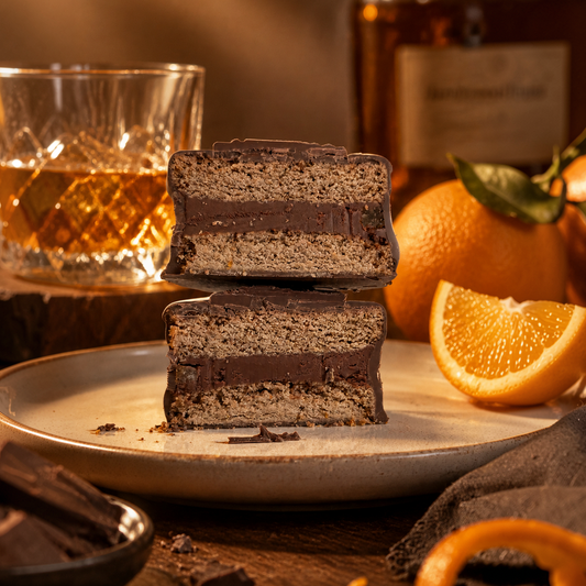 Handcrafted orange bourbon alfajor with orange ganache filling and chocolate coating, gourmet gift from Florida